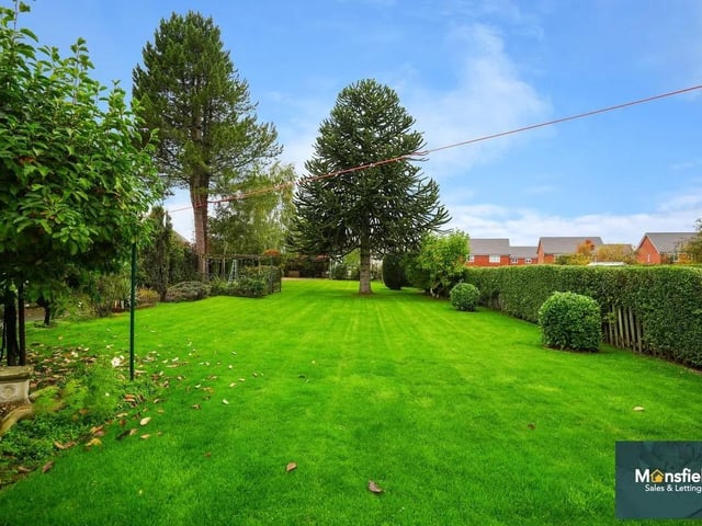 The stunning rear garden has a beautifully maintained space with a large lawn.