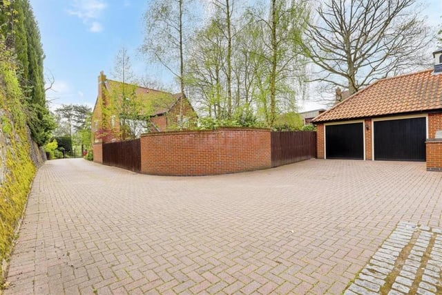 The block-paved driveway at the front of the property wends its way round to this double garage. As you can see, there is plenty of space for off-road parking.