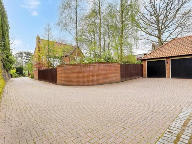 The block-paved driveway at the front of the property wends its way round to this double garage. As you can see, there is plenty of space for off-road parking.