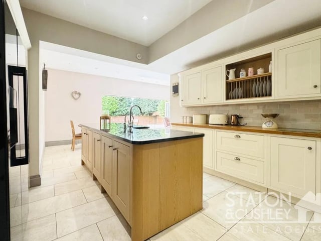 The contemporary kitchen is comprised of a range of high quality shaker style wall and base units, along with a complementary work surfaces. Complimented by a stunning centre island and a range of integrated appliances including a range cooker, microwave, dishwasher, Belfast sink, wine cooler and hot water tap.