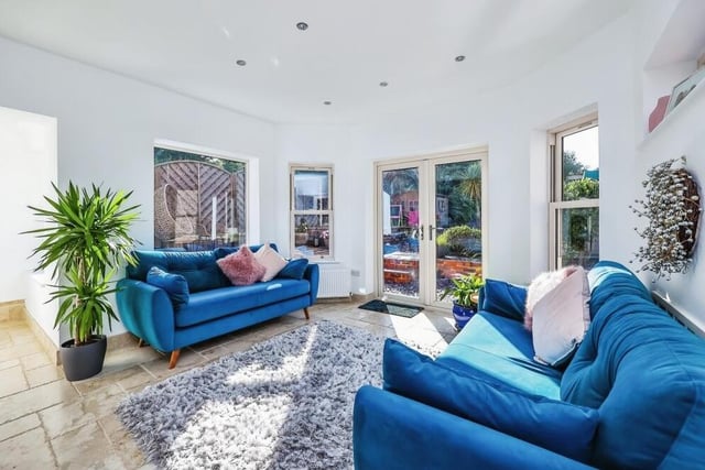 Here is a closer look at the living space that is part of the open-plan area on the ground floor. Bonny and bright, it features doors leading out to the garden.