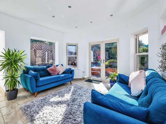 Here is a closer look at the living space that is part of the open-plan area on the ground floor. Bonny and bright, it features doors leading out to the garden.