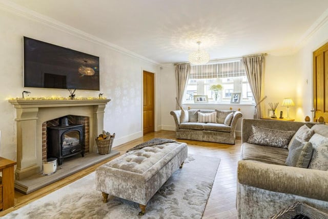 A highlight of the lovely living room is this feature fireplace with inset multi-fuel stove.