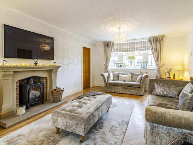A highlight of the lovely living room is this feature fireplace with inset multi-fuel stove.