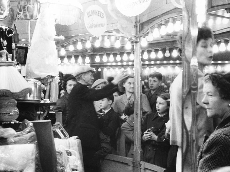 Visitors at one of the many stalls at the event, believed to be some time during the 1950s.