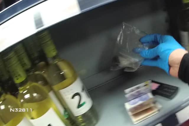 Jamie Cooke tried to hide drugs behind bottles of wine as police entered a shop to arrest him. (Picture: Nottinghamshire Police.)