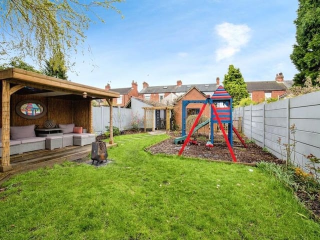 The back garden also includes a lawned area.