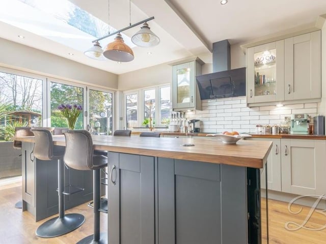 The centre island in the kitchen doubles up as a breakfast table with a large skylight above. It also contains a wine cooler.
