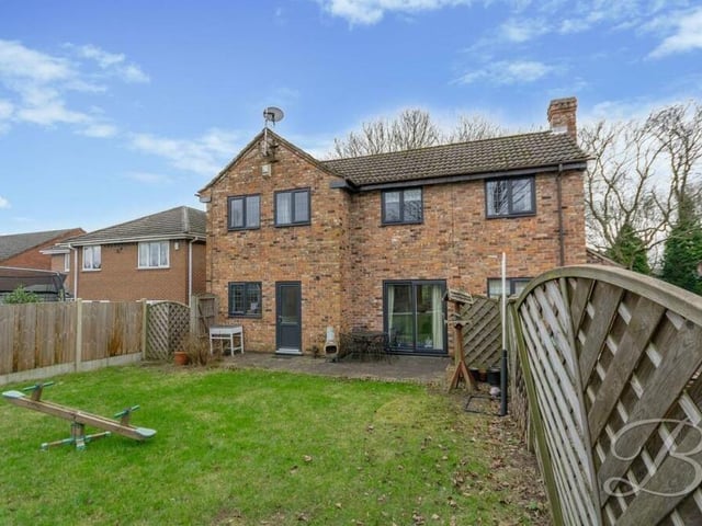 You've seen how the property looks from the front. This is a view from the rear, with the sliding doors leading to a patio seating area and the lawned back garden.