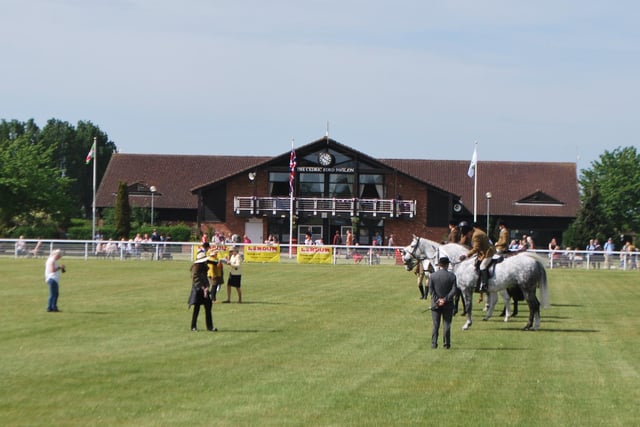 Equestrian judging in the main ring of the Nottinghamshire County Show, in front of the Cedric Ford Pavilion at the Newark Showground.