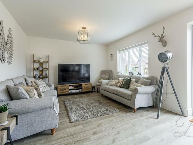 The living area within the open-plan space is bright, comfortable and relaxing, with a window overlooking the rear garden.