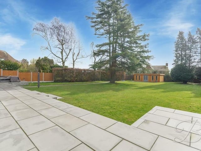 The rear garden in all its glory -- from the paved patio area to the summer house in the distance.