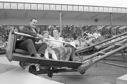 A family enjoys a funfair ride in Clipstone in 1973.