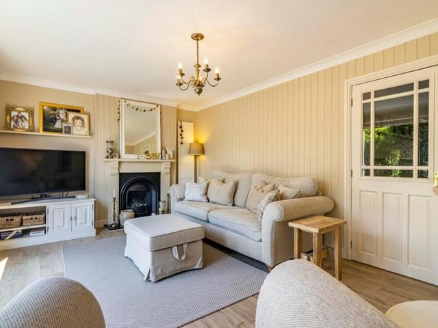 A second shot of the cosy and bright lounge, which has a wood-effect laminate floor.