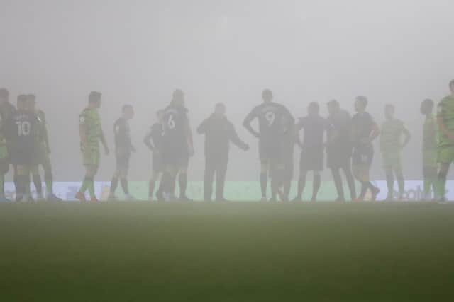 Players wait in vain for the match to restart at the Fully Charged New Lawn. Photo by Chris Holloway/The Bigger Picture.media