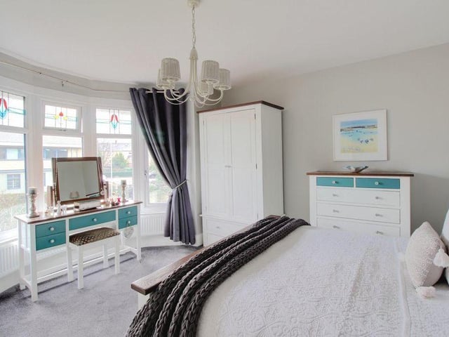This second shot of the main bedroom shows how bright the space is. The feature window offers decent views.
