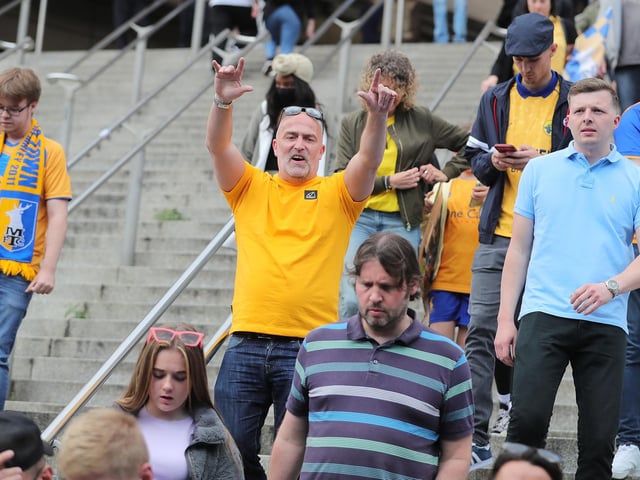 Mansfield Town fans watch the drama unfold inside Wembley.