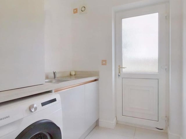 Before we go upstairs, there is also a practical cloakroom on the ground floor, with space for a washing machine.