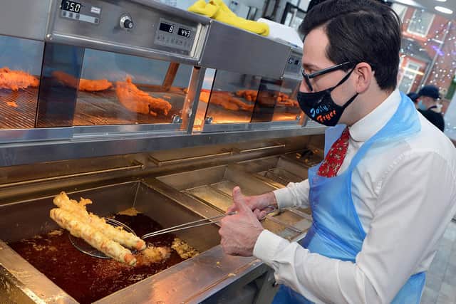 Theo Tsiolas, owner of the Jolly Frier in Kirkby, deep fries some battered pigs in blankets for Christmas.