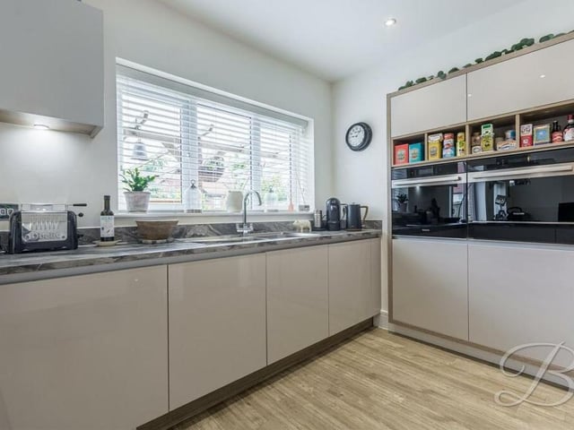 A stylish range of cabinets and units, with an inset sink and drainer, add merit to the kitchen, which faces the back of the £490,000-plus property.