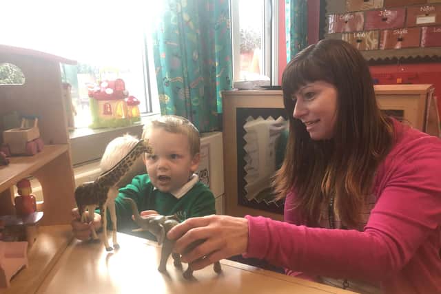 Noah and Miss Wood playing in the small world area at Oak Tree Primary & Nursery School
