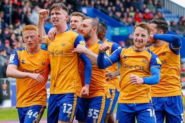 Mansfield Town's record-breakers celebrate Oli Hawkins' goal that made it 11 home wins in a row on Saturday. Photo by Chris Holloway/The Bigger Picture.media