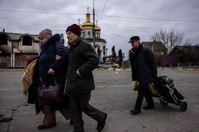 Evacuees flee the city of Irpin, northwest of Kyiv, on March 7, 2022.