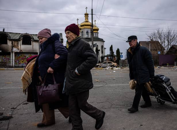 Evacuees flee the city of Irpin, northwest of Kyiv, on March 7, 2022.