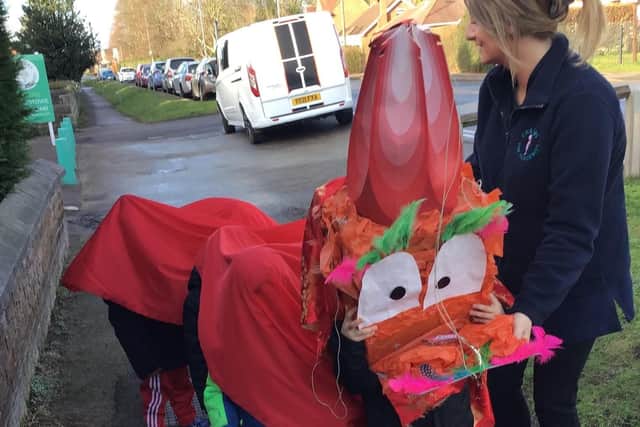 The children paraded around the village disguised as a Chinese dragon.
