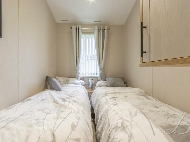 In the third bedroom, there is space for two single beds. The window faces the side of the property.