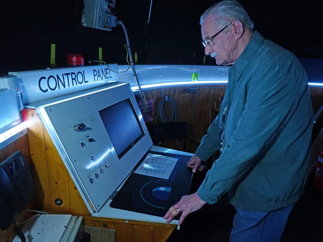 David Collins, founding member at the control panel for the telescope.