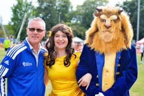 Craig French, event organiser, is all smiles with beauty and the beast.