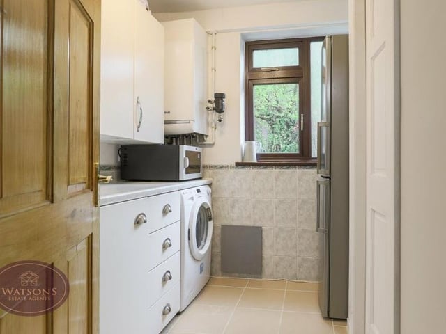 Just off the kitchen/diner is a handy utility room, which has plumbing for a washing machine and includes a wall-mounted-boiler. There is also a range of matching wall and base units.