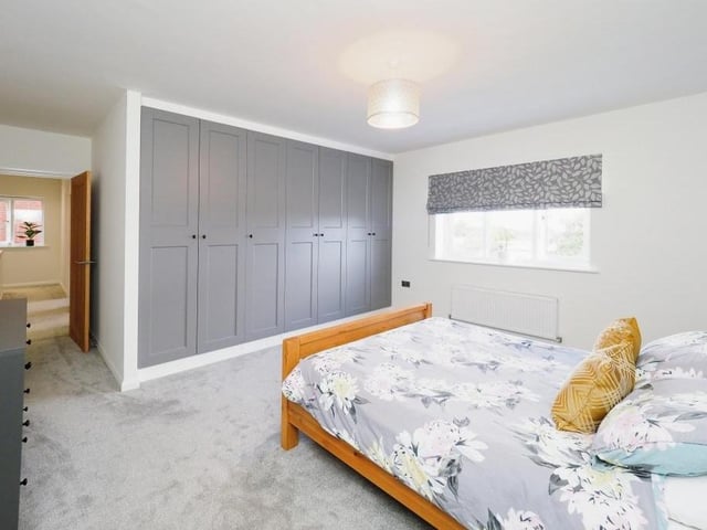 The master bedroom boasts huge, built-in wardrobes and has access to its own en suite bathroom.