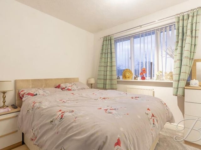The next double bedroom at the £525,000 family home overlooks the back garden. It comes with fitted carpets and fitted wardrobes.