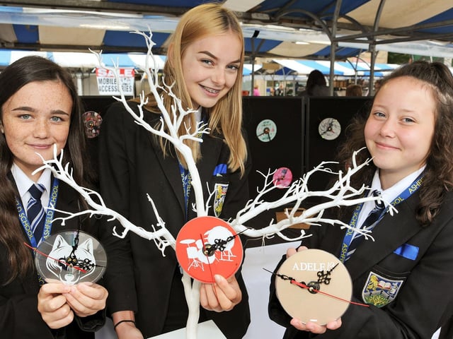 Ashfield School's Harley Everett, Neve Lawrence and Jess Rudd show off their 'Time Flies' clocks made from old CD's, which they sold on Mansfield Market at £5.