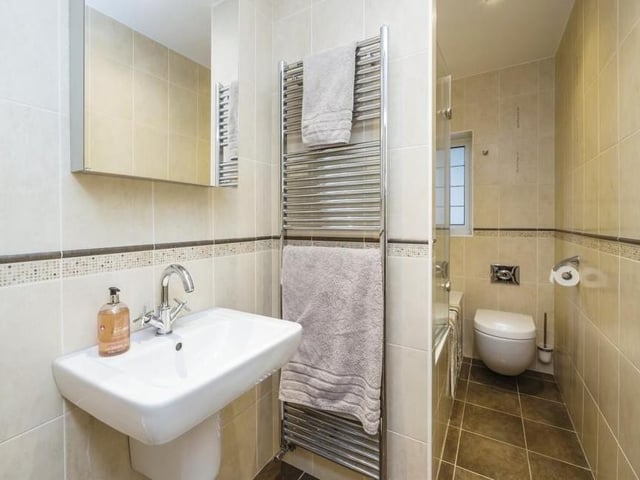Next stop is the family bathroom, which has a bath with power shower over. There is also a wash hand basin with mixer tap, WC, tiled splashbacks, tiled flooring and extractor fan.