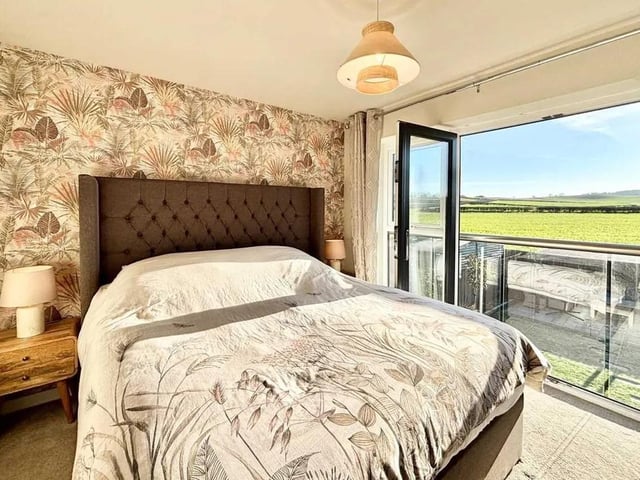 The master bedroom boasts a Juliet balcony, opening up to reveal a stunning view and benefits from built in wardrobes and its own private bathroom.