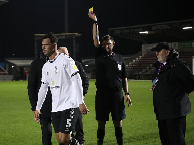 Harrison McGahey is shown a yellow card by referee Brett Huxtable at the the final whistle.