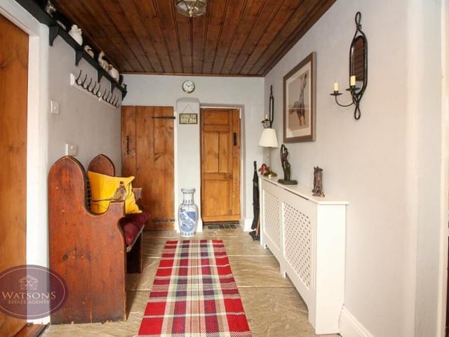 The tasteful hallway definitely has a touch of olde worlde about it. There's a solid oak entrance door, stone flooring and storage cupboard/cloakroom.