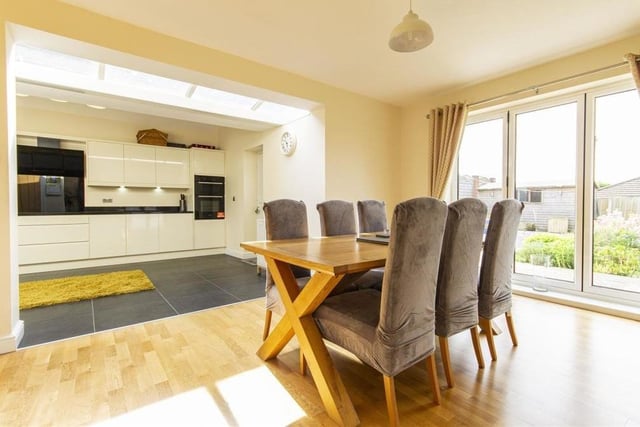 Part of the open-plan area is this dining room, a generously-sized reception room that overlooks and opens on to the patio in the back garden via bi-folding doors.