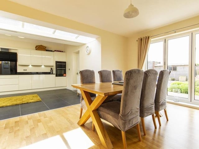Part of the open-plan area is this dining room, a generously-sized reception room that overlooks and opens on to the patio in the back garden via bi-folding doors.