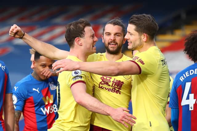 Burnley's English striker Jay Rodriguez (C) celebrates with teammates after he scores his team's second goal during the English Premier League football match between Crystal Palace and Burnley at Selhurst Park in south London on February 13, 2021. (Photo by Julian Finney / POOL / AFP) / RESTRICTED TO EDITORIAL USE. No use with unauthorized audio, video, data, fixture lists, club/league logos or 'live' services. Online in-match use limited to 120 images. An additional 40 images may be used in extra time. No video emulation. Social media in-match use limited to 120 images. An additional 40 images may be used in extra time. No use in betting publications, games or single club/league/player publications. /  (Photo by JULIAN FINNEY/POOL/AFP via Getty Images)