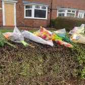 Floral tributes were left outside of the house in Sutton where a man in his 80s sadly died following a fire