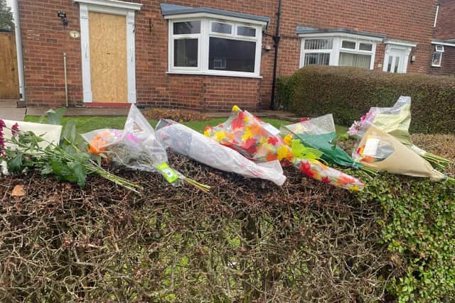 Floral tributes were left outside of the house in Sutton where a man in his 80s sadly died following a fire