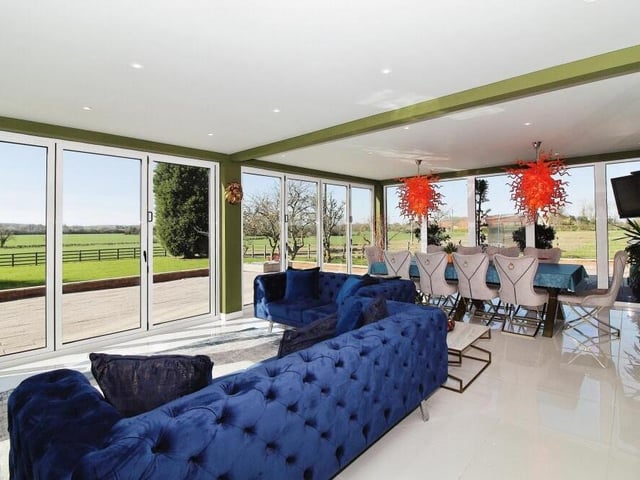The sun room or garden room offers spectacular views of the back garden and far-reaching countryside.