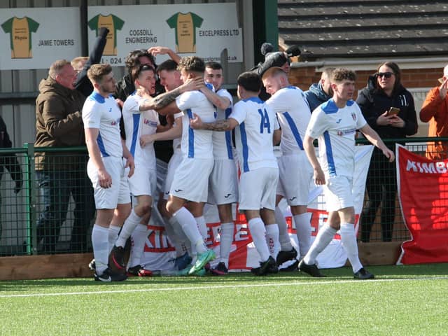 Kimberley celebrate scoring at Hinckley with the travelling fans. Photo: Wharton Images.