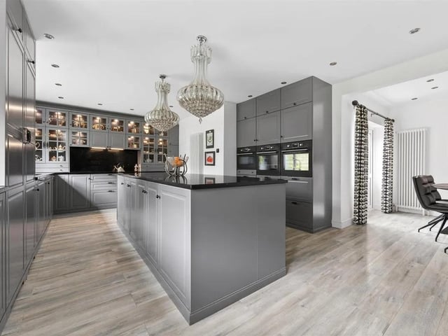 An Edwardian and substantial detached residence across three floors, together with a substantial detached coach house/double garaging with an adjoining workshop and room above. The star of the show is the superbly appointed, L-shaped, open plan dining kitchen. Integrated appliances include two single ovens, separate combination microwave oven, induction hob and built-in extractor hood above. Integrated dishwasher and integrated fridge and separate freezer. There is a large central island with double power socket and French doors leading out onto the rear garden.