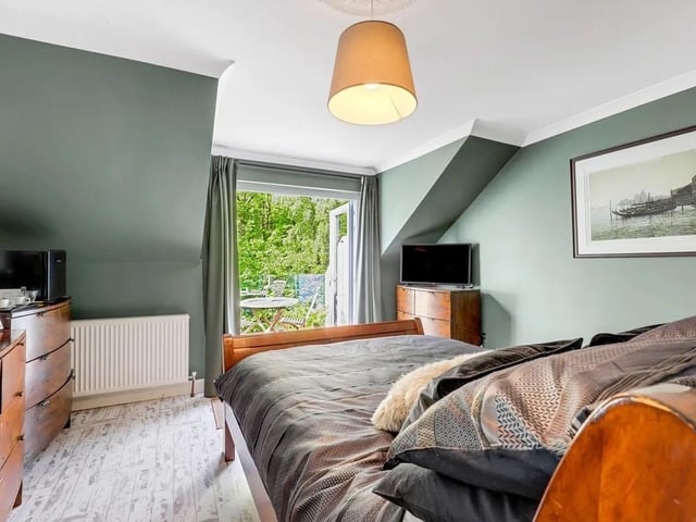 The master features double French doors with triple-glazing opening out onto a private balcony area enjoying elevated views over the surrounding conservation woodland