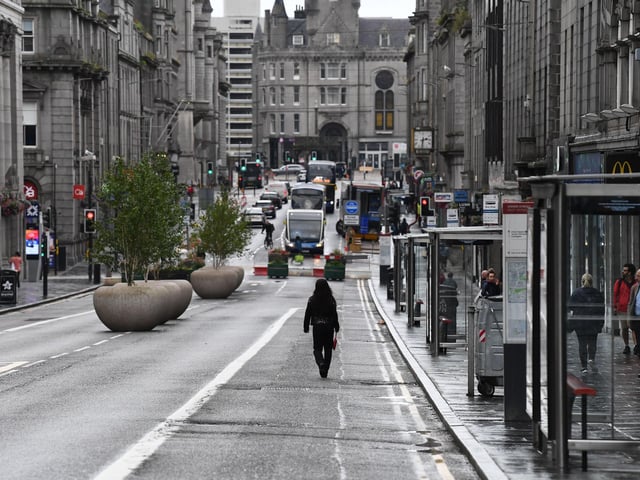 A pedestrian walks down an empty street. (Photo by Jeff J Mitchell/Getty Images)